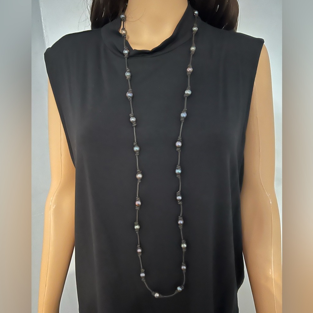 FRESH WATER PERL NECKLACE OYSTER COLOR 50 INCH LONG .ON BLACK LEATHER.
